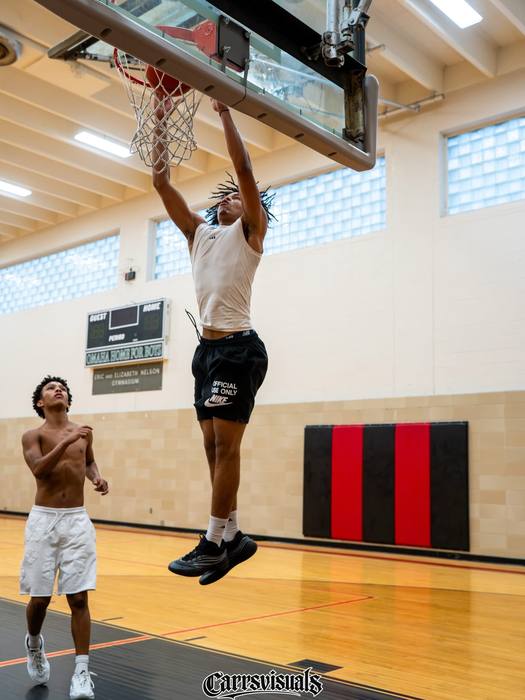 Player rising for a dunk in an open gym
